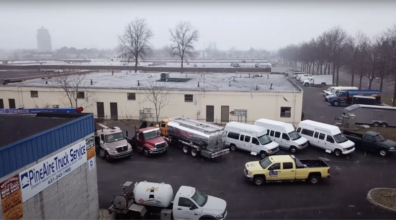 A picture of various trucks in a diesel truck repair yard