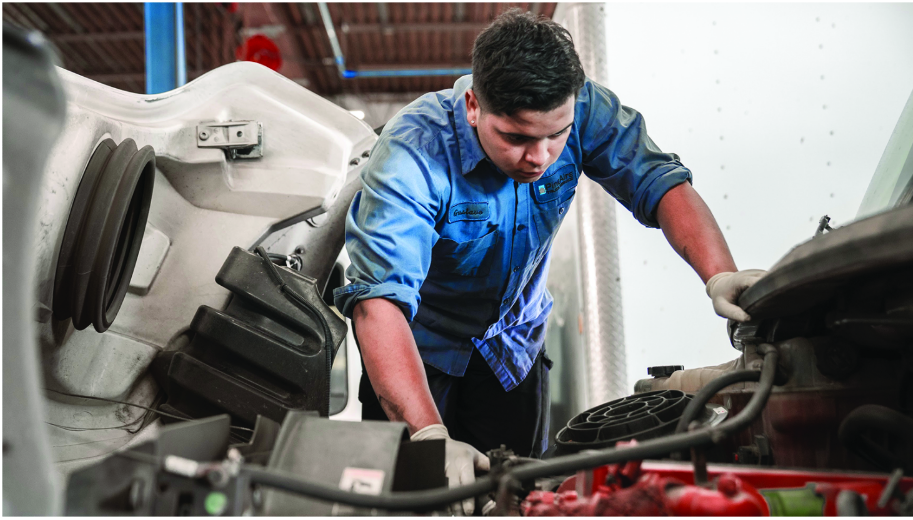 A picture of Jim, a mechanic working in the inside of a semi truck