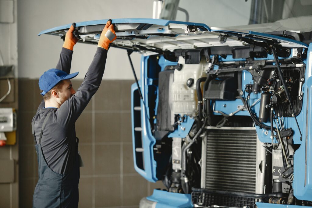 Mechanic opening hood on large semi truck