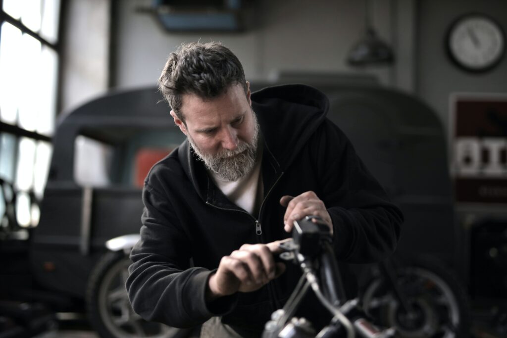 A truck repair technician using an OBD diagnostics scanner