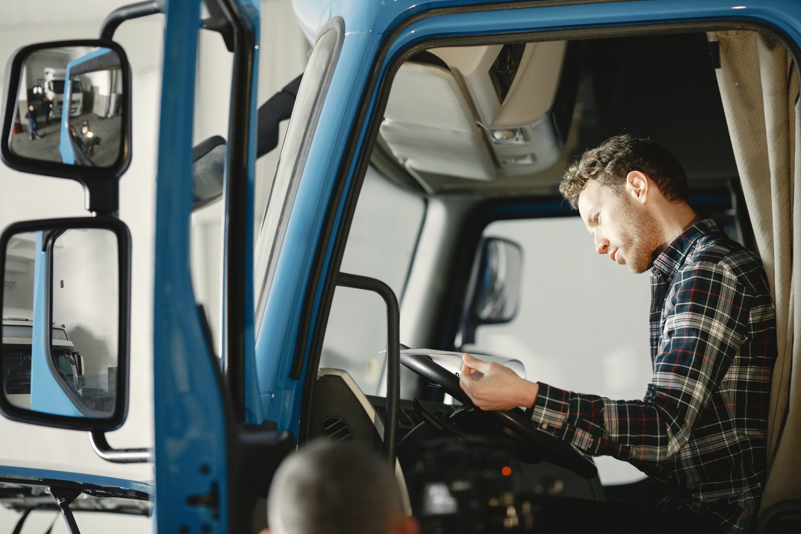 Person sitting in the driver seat reviewing a sheet in a truck